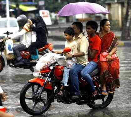 Motorcycle in Rain with four passenger in India